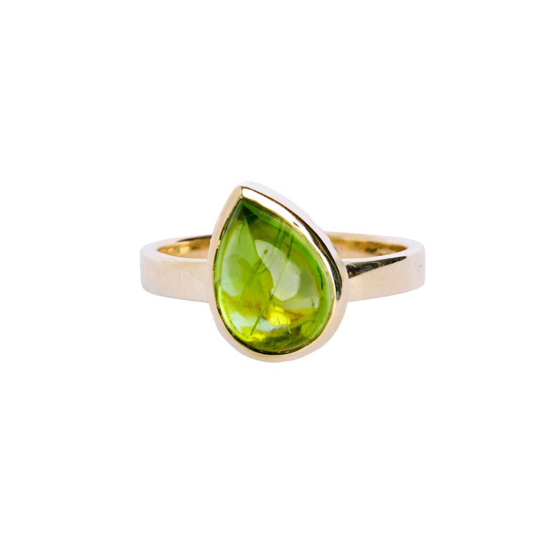 9ct yellow gold ring with a teardrop shaped peridot cabochon, which is a moss green gem, in a bezel setting. The band is flat in shape and is 3mm wide. The 9ct yellow gold band is 3mm wide.