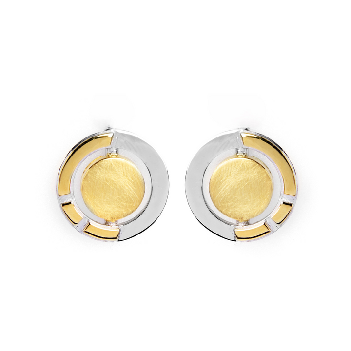The Urú Studs by Gallardo & Blaine Designs feature round Celtic-inspired earrings with a central gold-toned circle, sterling silver outer ring, and geometric gold accents—a timeless nod to classic Irish jewellery, shown on a white background.