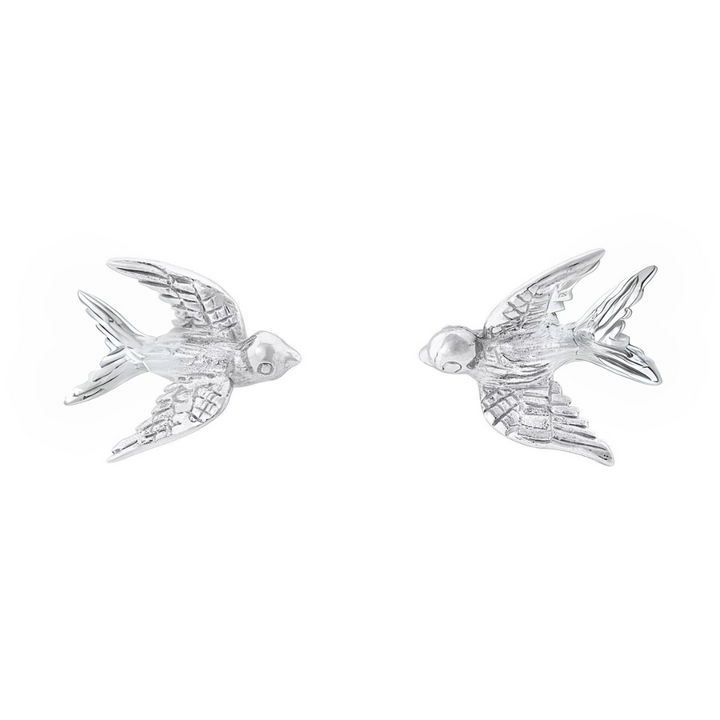 The Wildlife Swallow Studs by Gallardo & Blaine Designs feature two sterling silver earrings with feather-textured wings and tails, facing each other on a white background—a timeless piece of Irish jewellery.