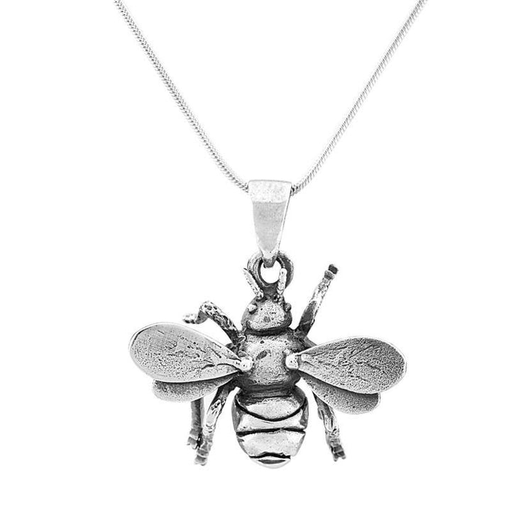 A close-up image of a sterling silver necklace featuring a detailed bee pendant. The pendant captures the bee with textured wings, body, and legs. The Gallardo & Blaine Designs Wildlife Pendant - Small Bee With Chain has a thin, elegant chain. The background is white, highlighting the pendant's intricate design.