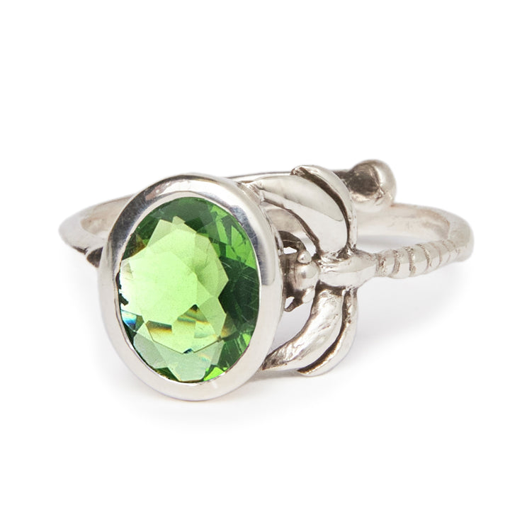 The Daydream Ring by Gallardo & Blaine Designs features an ornate, adjustable sterling silver gold-plated band with a striking oval green gemstone for a refined look.