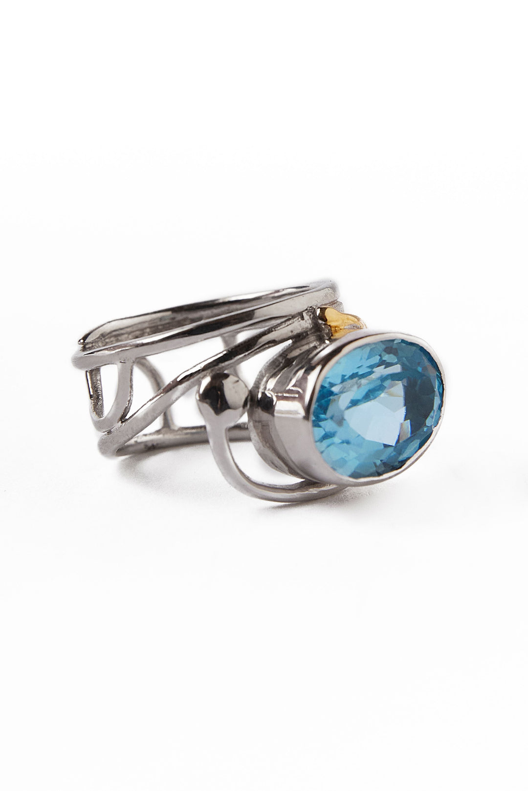 Gallardo & Blaine Designs' Horizontal Ring showcases a modern silver and gold band with intricate patterns, accentuating a prominent oval blue gemstone.