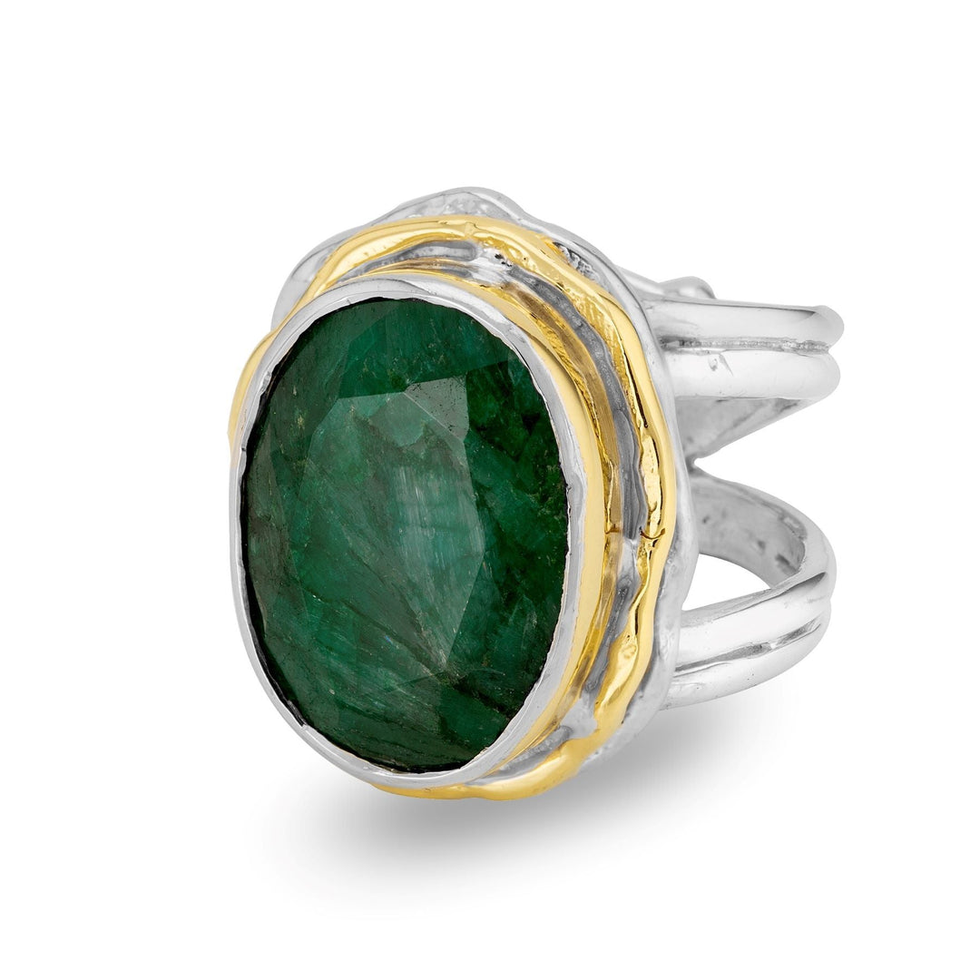 The Magnolia Ring in silver gold & various gemstones by Gallardo & Blaine Designs is a statement piece, featuring a large, oval-shaped green gemstone in a faceted cut. Set with gold accents on a sterling silver band that elegantly splits into multiple strands, this ring blends sophistication and charm seamlessly.