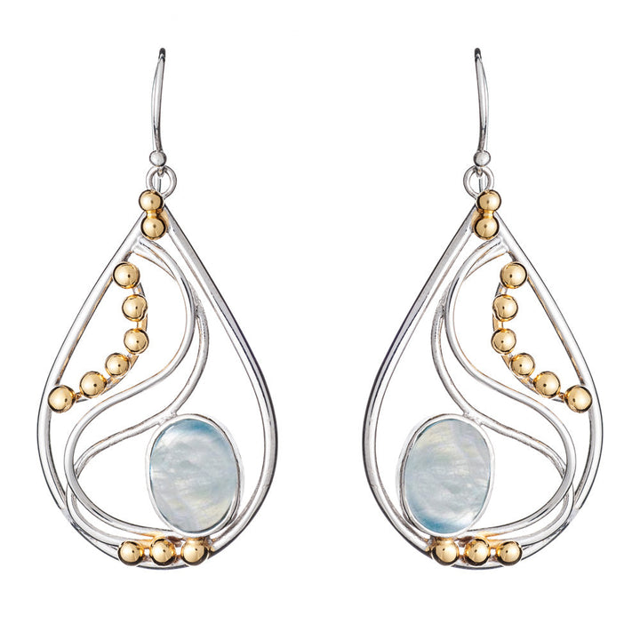 A pair of Phoenix Earrings in various gemstones featuring a combination of silver and gold tones. These elegant teardrop-shaped earrings by Gallardo & Blaine Designs have a large central opalescent stone, accented by curved silver lines and small gold spherical beads arranged along the inner edges.