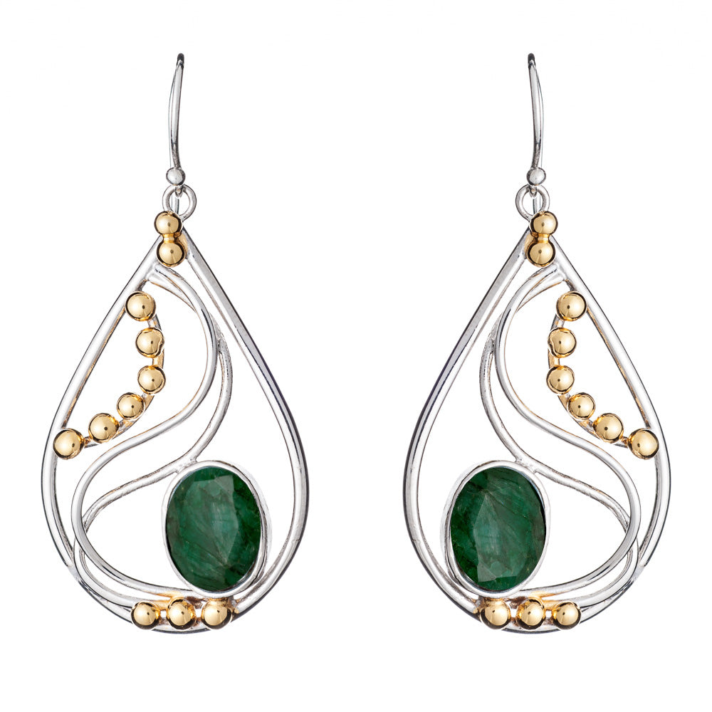 These elegant Phoenix Earrings in various gemstones from Gallardo & Blaine Designs are teardrop-shaped with a blend of silver and gold-colored elements. Each earring features a large green gemstone at the center, complemented by a wavy silver design and gold-colored beads. The silver and gold earrings have a hook for wearing.