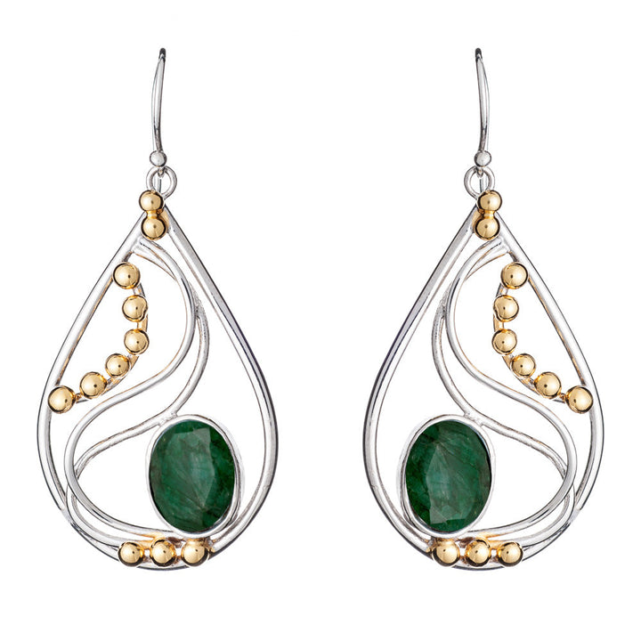 These elegant Phoenix Earrings in various gemstones from Gallardo & Blaine Designs are teardrop-shaped with a blend of silver and gold-colored elements. Each earring features a large green gemstone at the center, complemented by a wavy silver design and gold-colored beads. The silver and gold earrings have a hook for wearing.