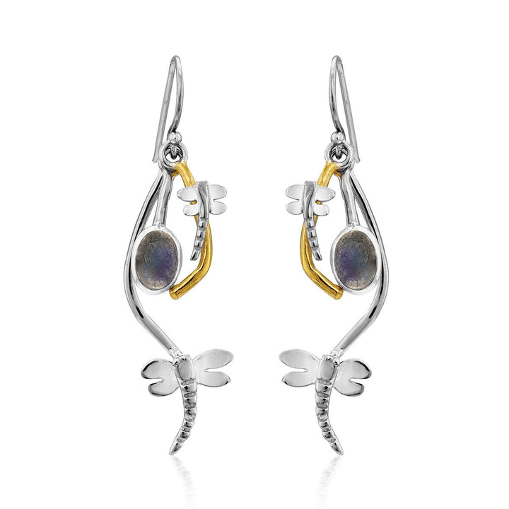 A pair of Ripple Earrings in various gemstones by Gallardo & Blaine Designs featuring a whimsical dragonfly design. Each silver dangle earring has a curved body, gold accents, and a round iridescent gemstone. The earrings have a hook for wearing.