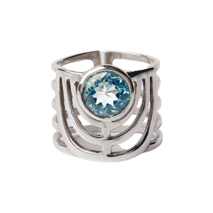 The Solar Ring by Gallardo & Blaine Designs features a large round blue gemstone set in a chunky, open geometric sterling silver band.