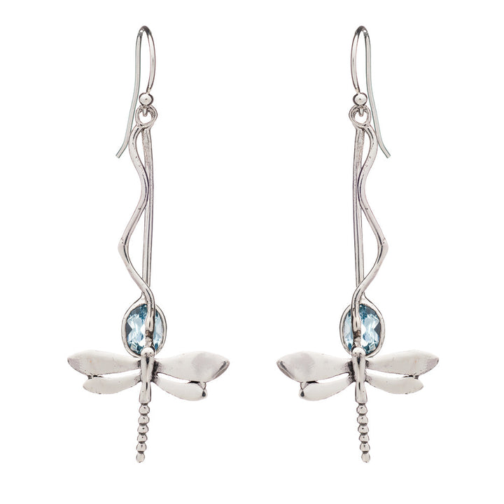 A pair of silver dangle earrings featuring intricate silver dragonfly designs. Each dragonfly is adorned with a light blue gemstone at its center, and the earrings have long, elegant hooks that resemble twisting vines. Introducing the Willow Earrings in Various Gemstones from Gallardo & Blaine Designs.