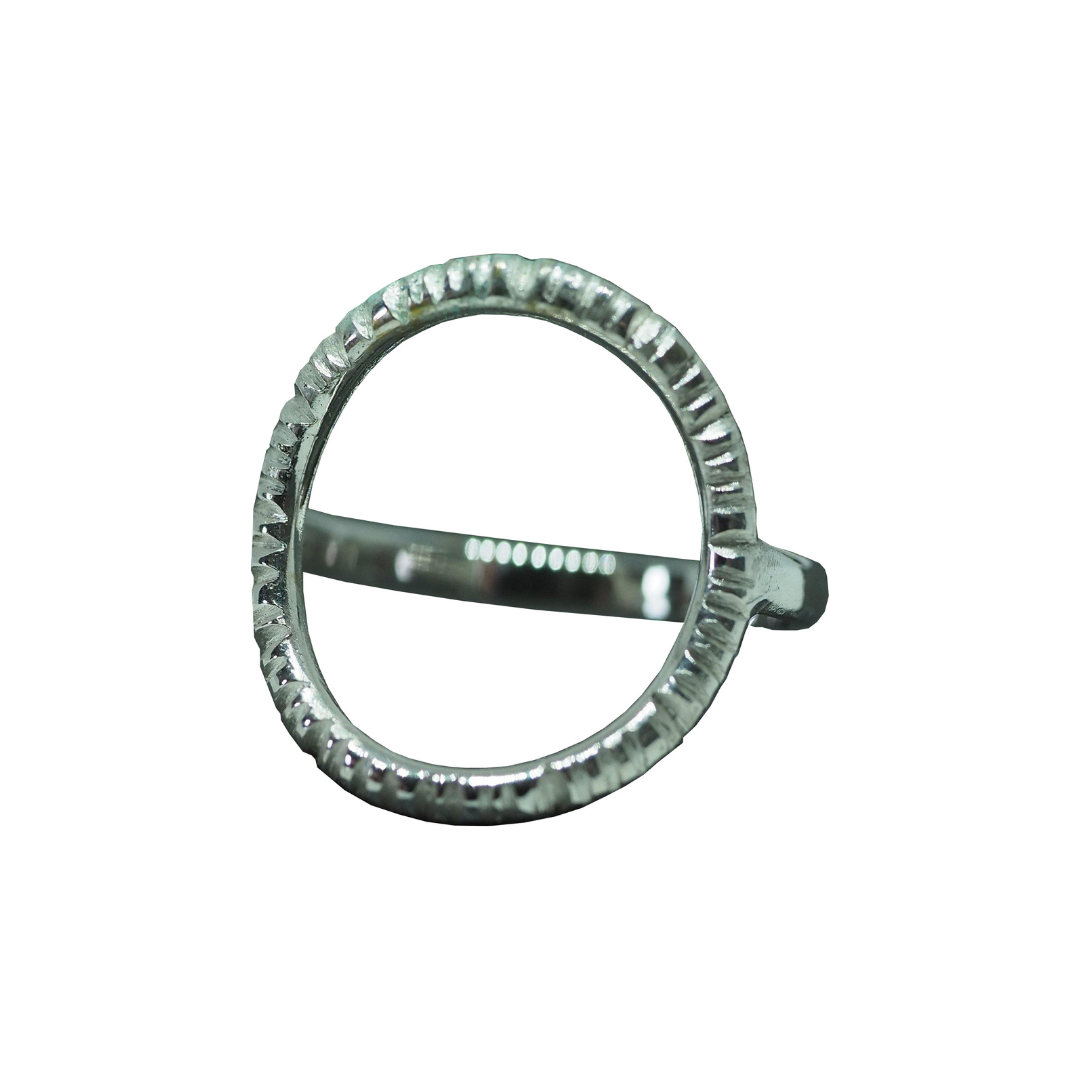 The Into The Light Ring Silver by Aud features a bold, textured open circular centerpiece in sterling silver, showcased against a white background.