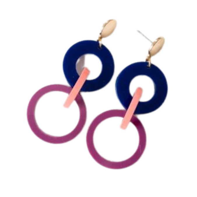 A pair of modern, geometric earrings featuring gold studs with dangle elements. These handmade Studio Nok Nok Navy, Pink & Magenta Acrylic Fire Earrings showcase a stacked design: a blue ring at the top, connected to a pink rod, which links to a larger purple ring at the bottom. Made from recycled acrylic, they are smooth, polished, and lightweight.