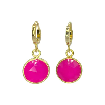A pair of gold hoop earrings with dangling round, faceted hot pink gemstones. Handcrafted in Dublin, the gems are set in gold-plated brass bezels, giving the Pink Chalcedony Drop Earrings by Aria V a classy and elegant appearance.