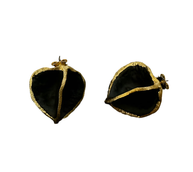 A pair of Coffee Bean Stud Earrings in matt black, from the brand Georgia Charal, featuring a unique design resembling leaves with a textured gold-plated border. One earring is shown from the front, while the other displays the back and post.