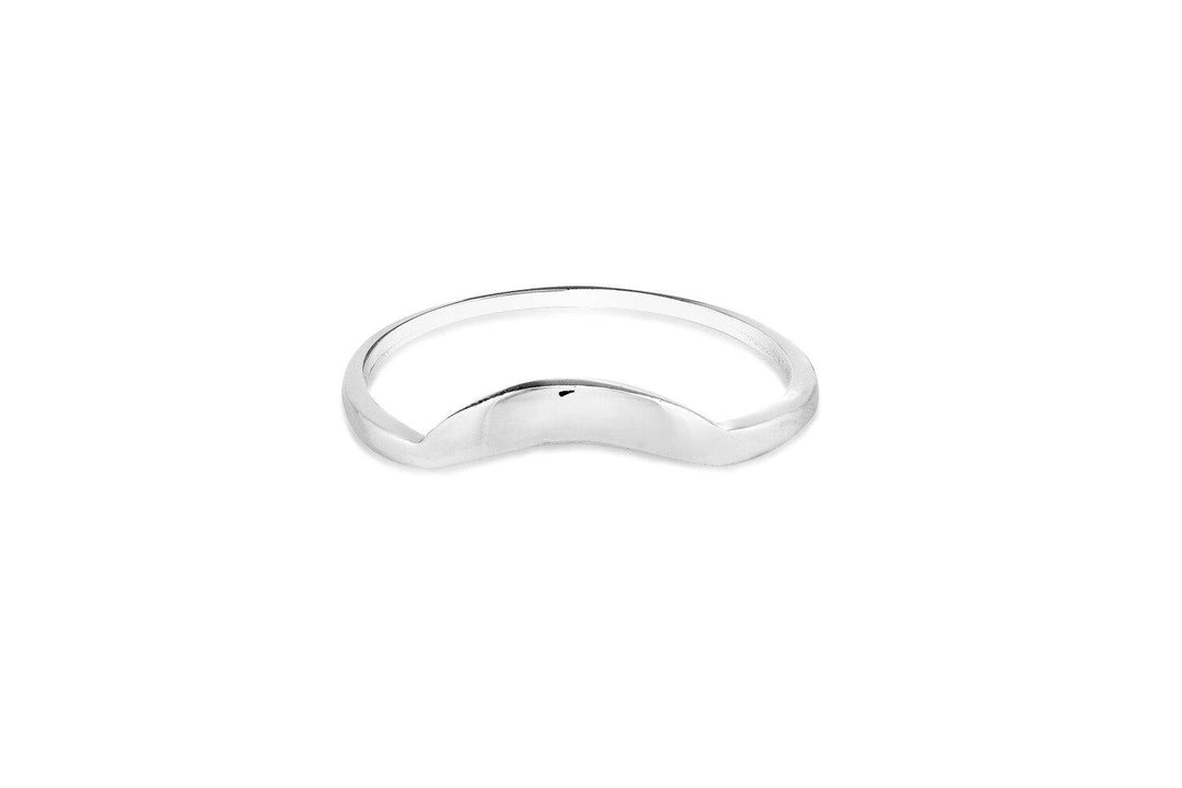 A minimalist Sunrise Ring Silver from Cosmic Boulevard with a sleek, smooth surface featuring a curved, crescent-shaped indent at the front. The ring has a shiny, polished finish and can be elegantly paired with other stacking rings.