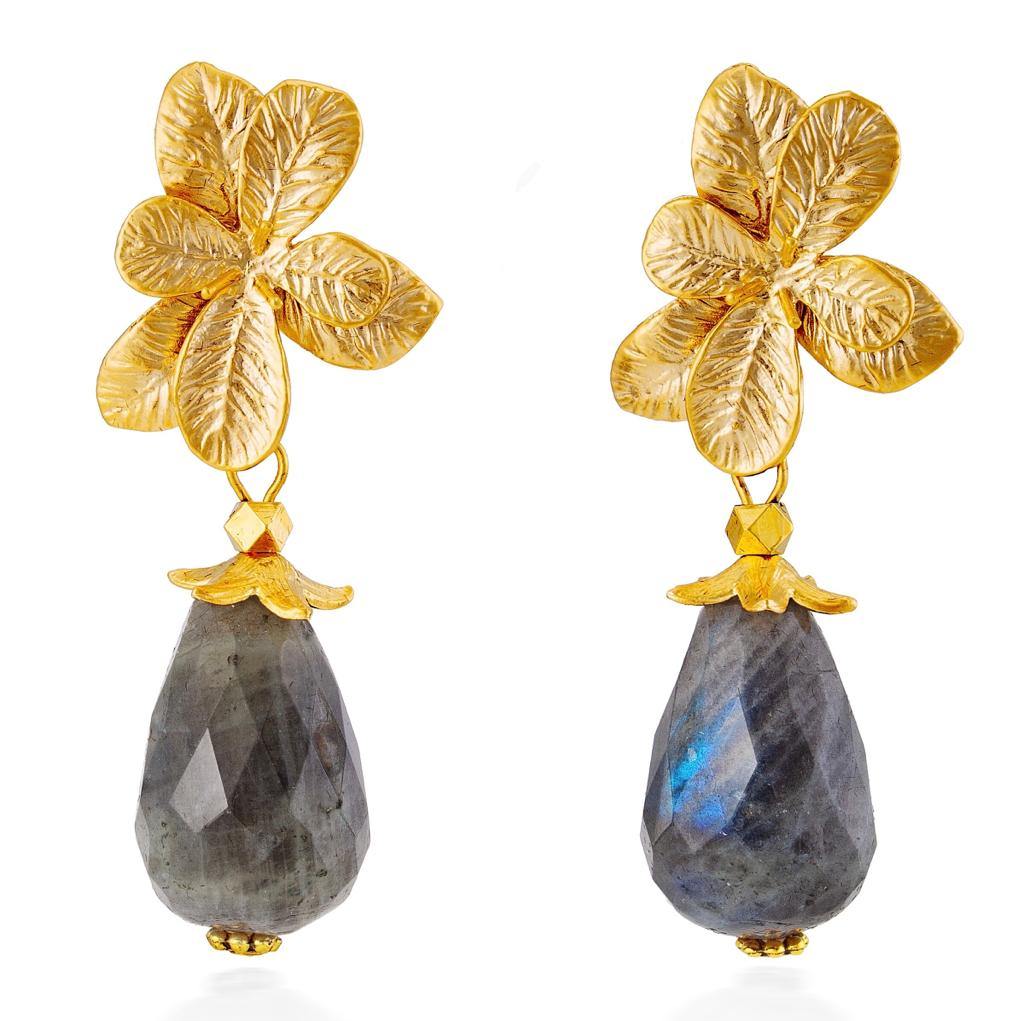 A pair of Flora Earrings by Aria V featuring intricate matte gold plated flower studs at the top and large, handcrafted labradorite teardrops hanging below. The gold flowers have detailed leaf textures, adding a sophisticated touch to the overall design.