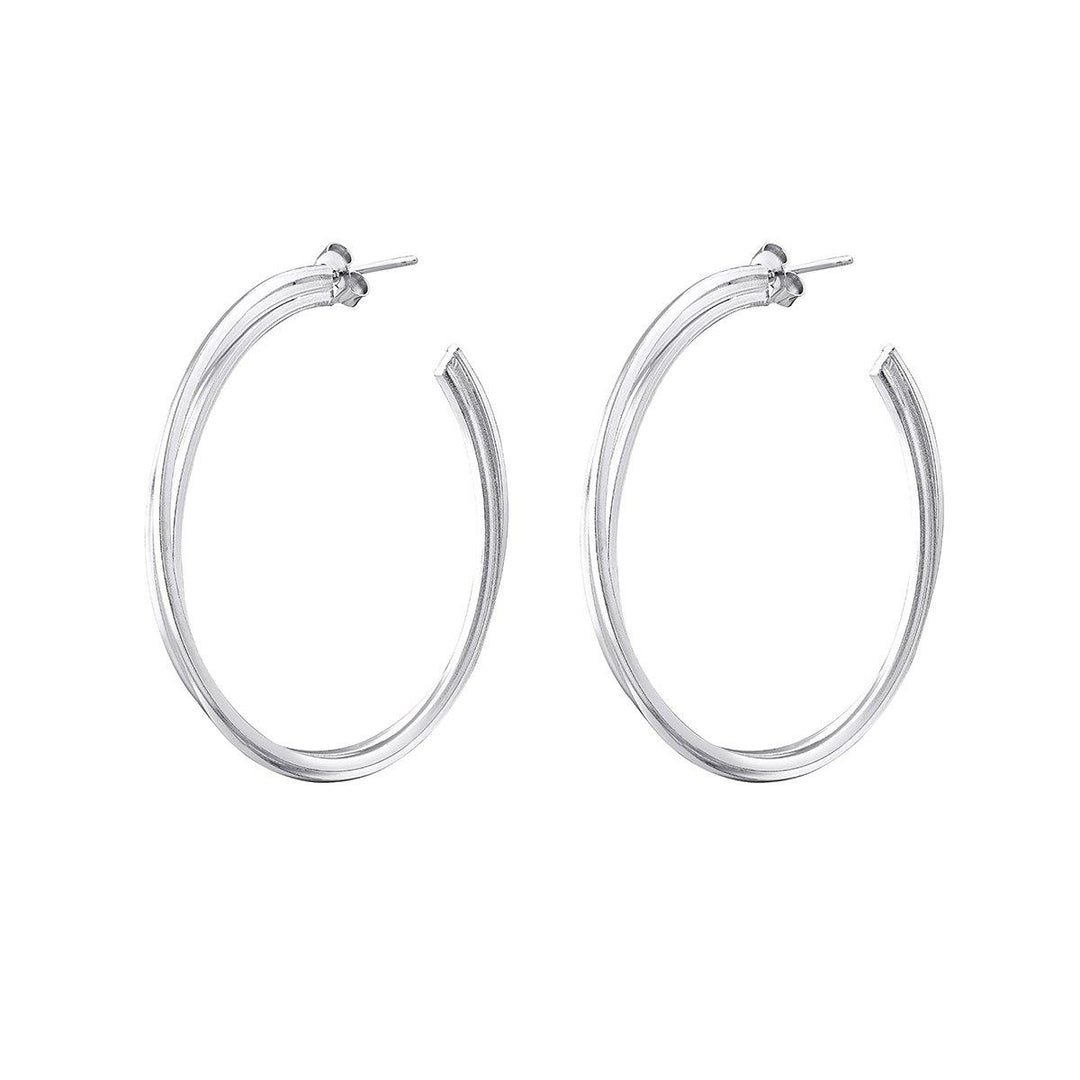 A pair of Triple Silver Hoops by Watermelon Tropical with a smooth, polished finish. The hoops are medium-sized, featuring a thin, classic design and post-back closures. Each earring is slightly open at the bottom, adding a unique twist to the traditional chunky hoop earrings style.