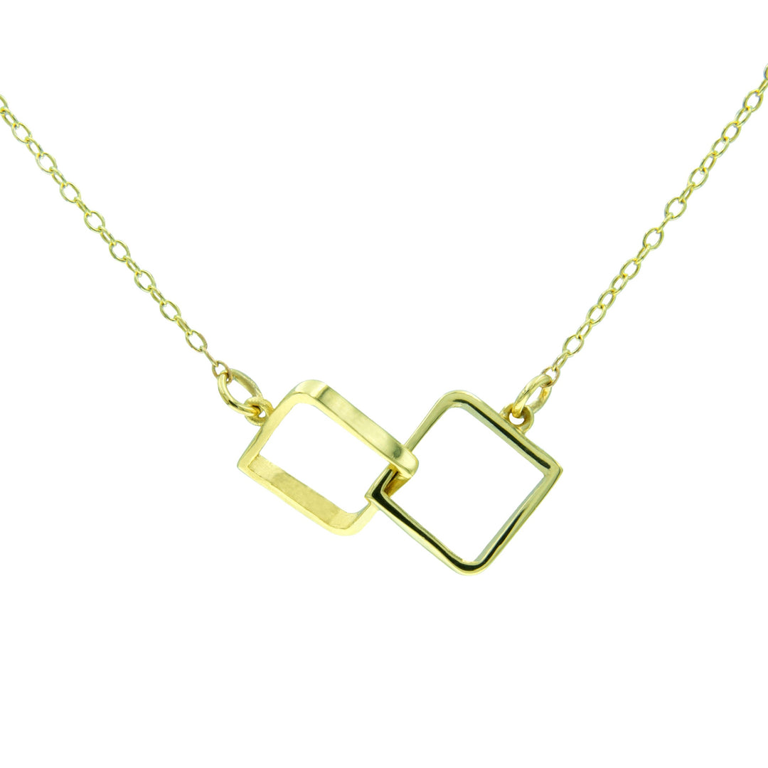 A delicate 9ct yellow gold necklace featuring two interlocking open square pendants. The dainty linked pendants are joined at a slight angle, and the necklace has a fine gold chain. The design is minimalistic and modern, perfect for any jewellery collection. This exquisite piece is known as the Le Cheile Square Pendant 9ct Yellow Gold by Miriam Wade.