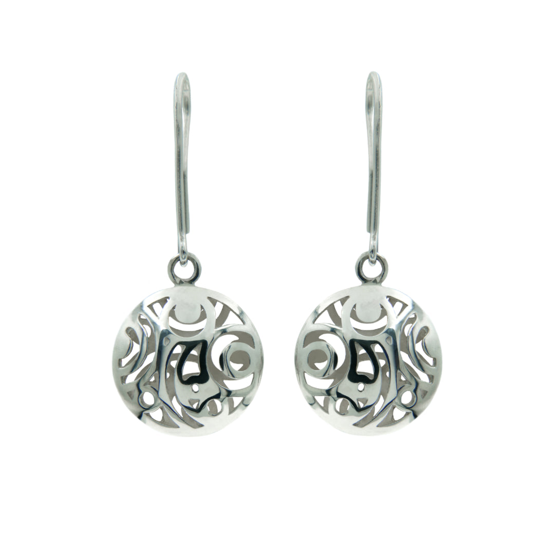 Líos Drop Earrings Silver by Miriam Wade with a circular filigree design, featuring intricate swirls and cut-out patterns, hanging from French hook ear wires against a plain white background. These handmade silver earrings evoke the charm of the Irish countryside, blending tradition with elegance.
