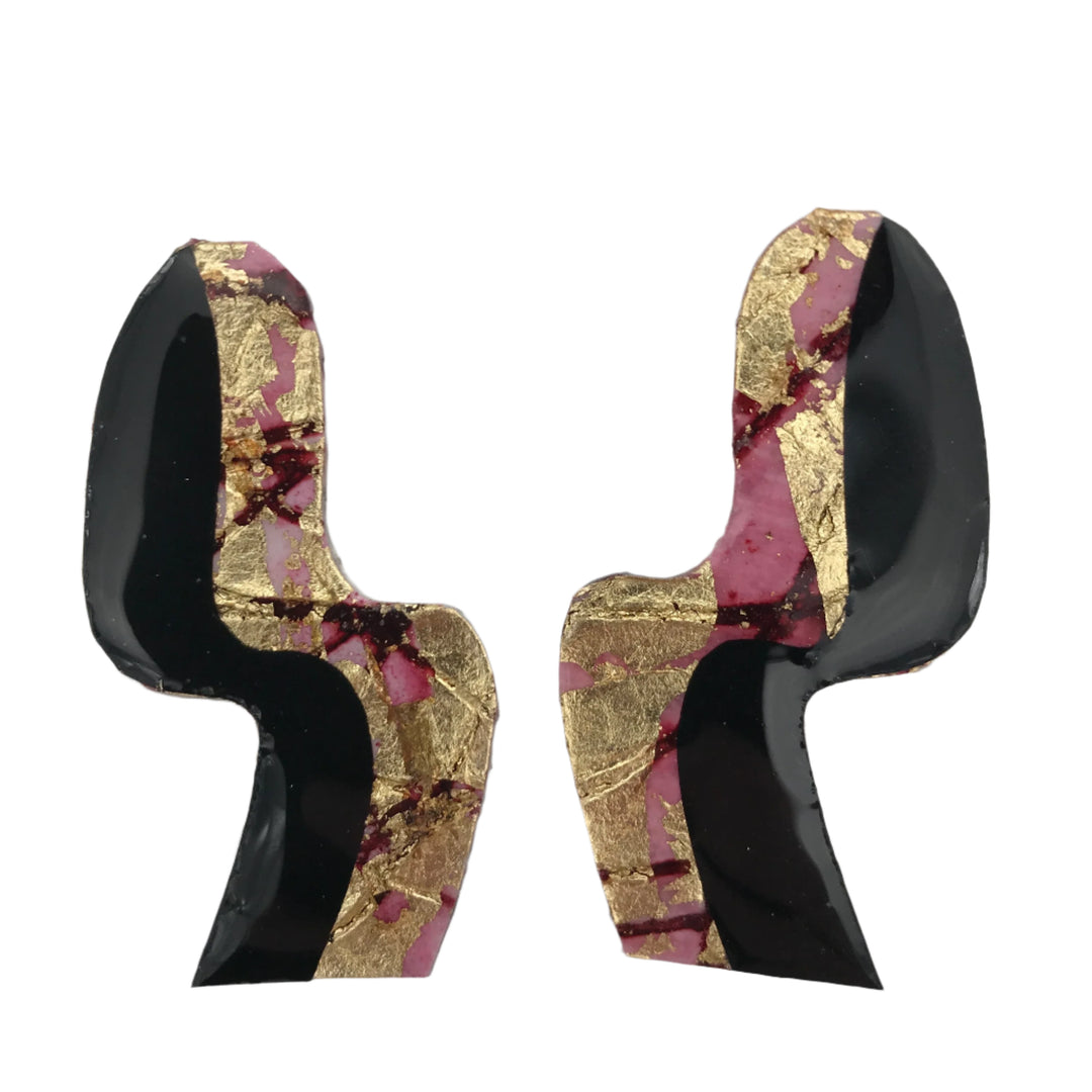 A pair of Swerve Post Earrings in Gold/Red Sgraffito/Black by Rothlú with an asymmetrical design. These hypo-allergenic silver plated earrings feature a combination of black, pink, and metallic gold accents, creating a striking and artistic look. The background is plain white, highlighting the vibrant colors and unique textures of the earrings.