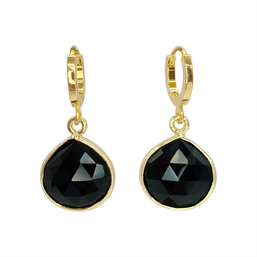 A pair of handcrafted Agate Drop Earrings with gold hoops and teardrop-shaped black faceted stones set in gold plated brass by Aria V. The earrings are displayed against a white background.
