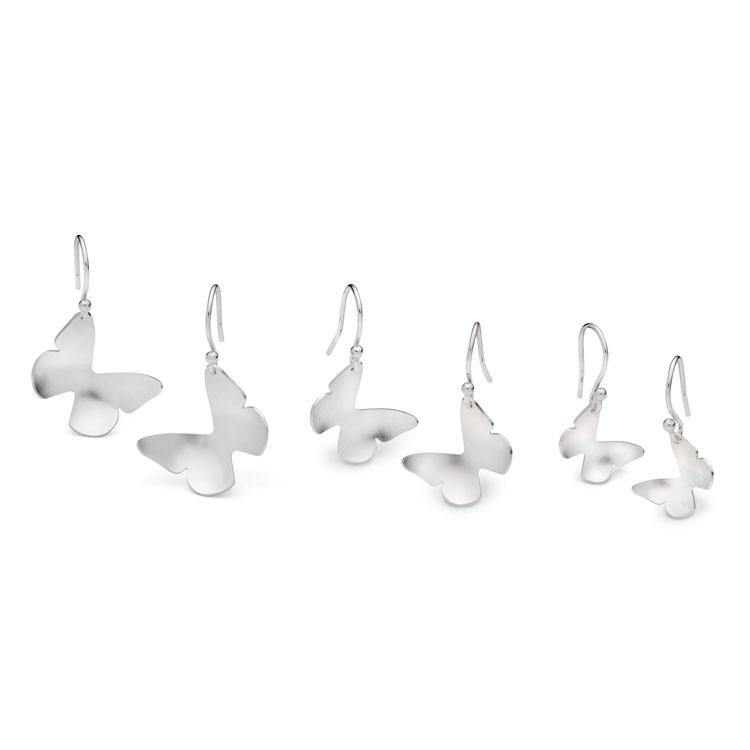 A set of five pairs of **Leoma Drew Butterfly Drop Earrings** arranged in a row. Each pair features a minimalist butterfly design with hooks for easy wearing. The sizes range from large on the left to small on the right.