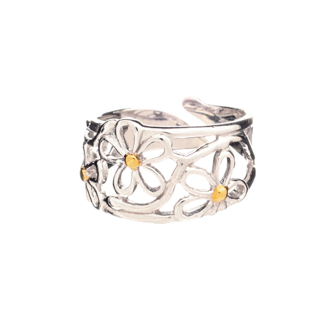 An adjustable Daisy Ring in Silver & Gold by Gallardo & Blaine Designs featuring an intricate design of openwork daisies. The flowers have small yellow centers, and the band has a textured, slightly oxidized finish, highlighting the floral design.