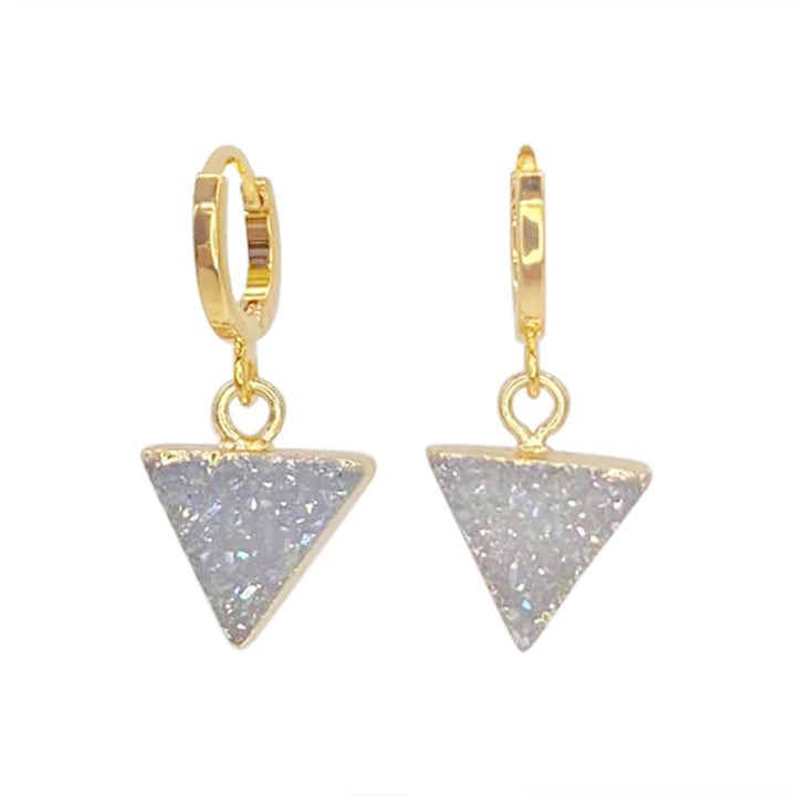 A pair of Aria V Dune Earrings featuring 14k gold-plated brass hoops with dangling triangular pendants encrusted with sparkly, iridescent crystals. The shiny finish enhances the beauty of these stunning earrings, shown against a plain white background.