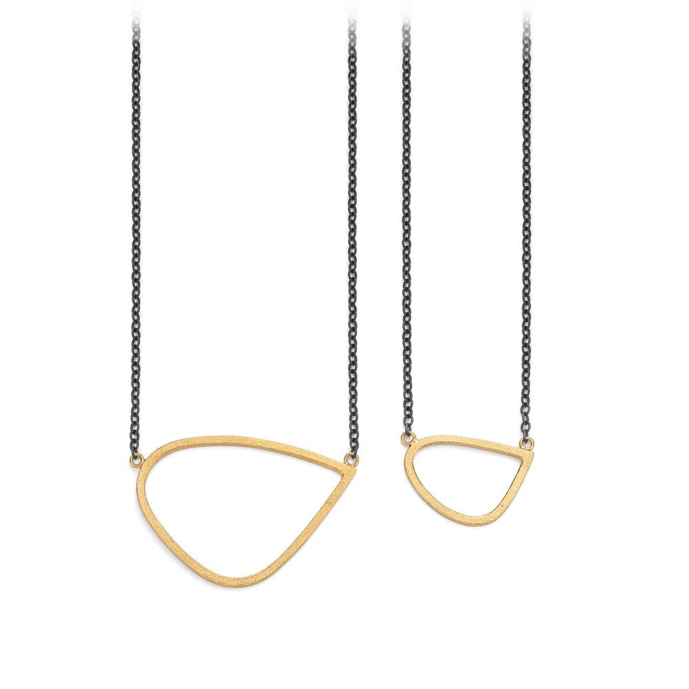 Two necklaces with oxidised silver chains from Leoma Drew, each featuring a unique, asymmetrical, gold vermeil geometric pendant. The necklace on the left, named Gold Wing Pendant with Oxidised Silver Chain, has a larger tear drop-shaped pendant, while the necklace on the right has a smaller pear-shaped pendant.