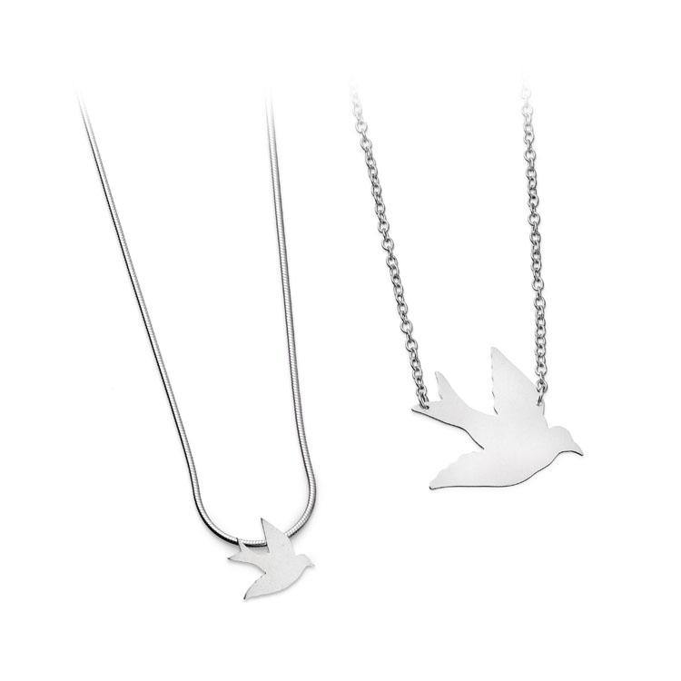 Two silver necklaces are shown, each showcasing Leoma Drew Swallow Pendants. One necklace features a smooth snake chain, while the other has a standard chain link design. Both handcrafted pendants appear to be made of polished metal, set against a white background.