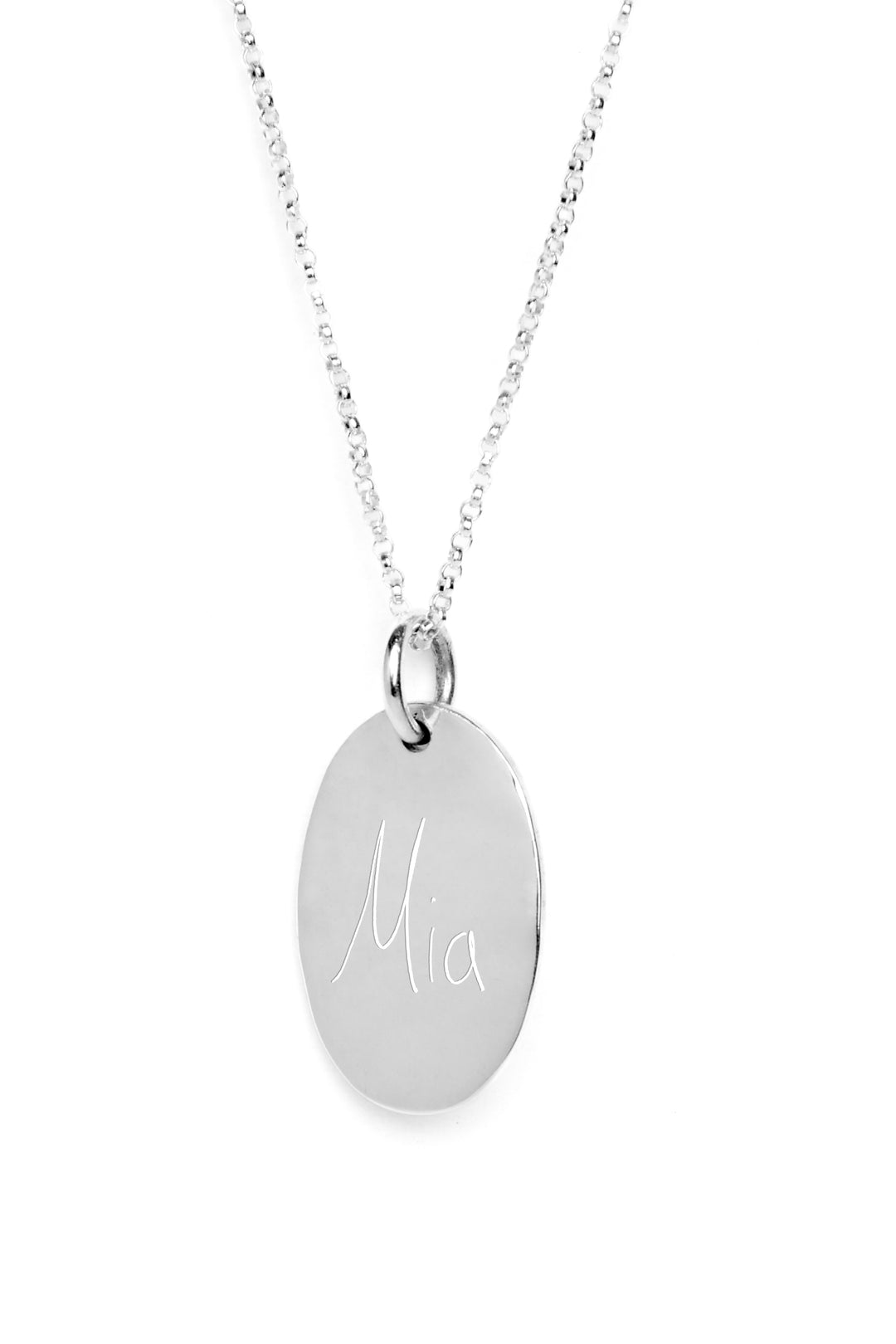 Silver necklace with a round, flat pendant engraved with the name "Mia" in cursive letters, displayed against a white background.