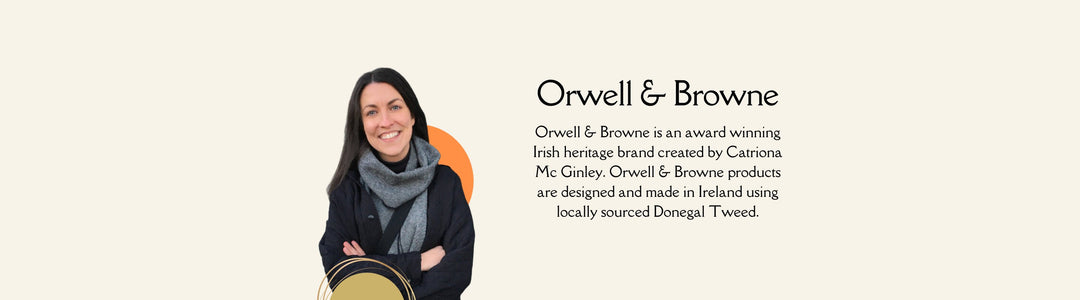 A woman wearing a scarf and black coat smiles with arms crossed in front of a display for Orwell & Browne, an award-winning Irish heritage brand creating products from locally sourced Donegal Tweed. Text about the brand is to the right.