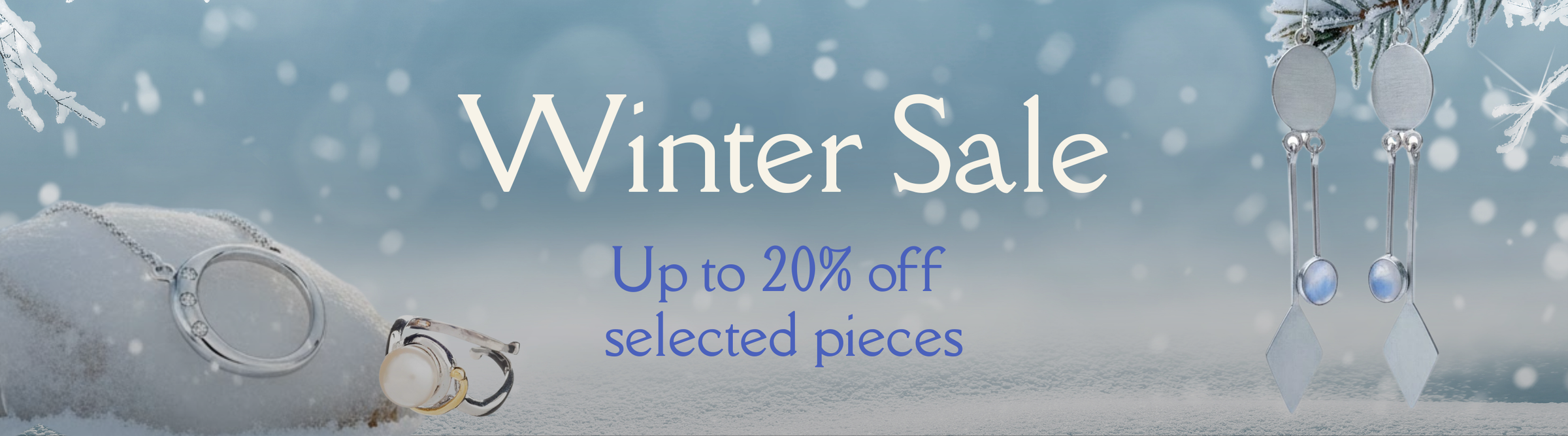 Winter Sale banner with rings and earrings on a frosty, snow-covered background. Text reads: "Winter Sale. Up to 20% off selected pieces.