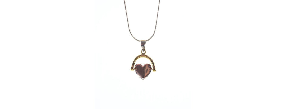 A gold necklace with a thin chain features a brown heart-shaped pendant framed by a gold semicircle. The pendant hangs centered on a white background.