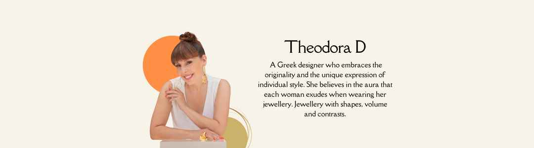 A woman with a top bun hairstyle and white sleeveless top sits at a desk, smiling and holding chin with one hand. Text beside her reads: Theodora D, a Greek designer focused on unique, individual style and expressive jewelry designs.