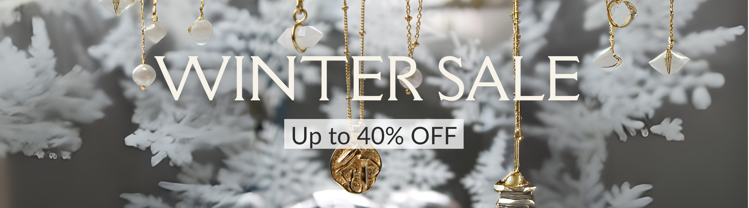 Gold ornaments hanging in front of a blurred, snowy background with the text "WINTER SALE" and "Up to 40% OFF" displayed prominently.