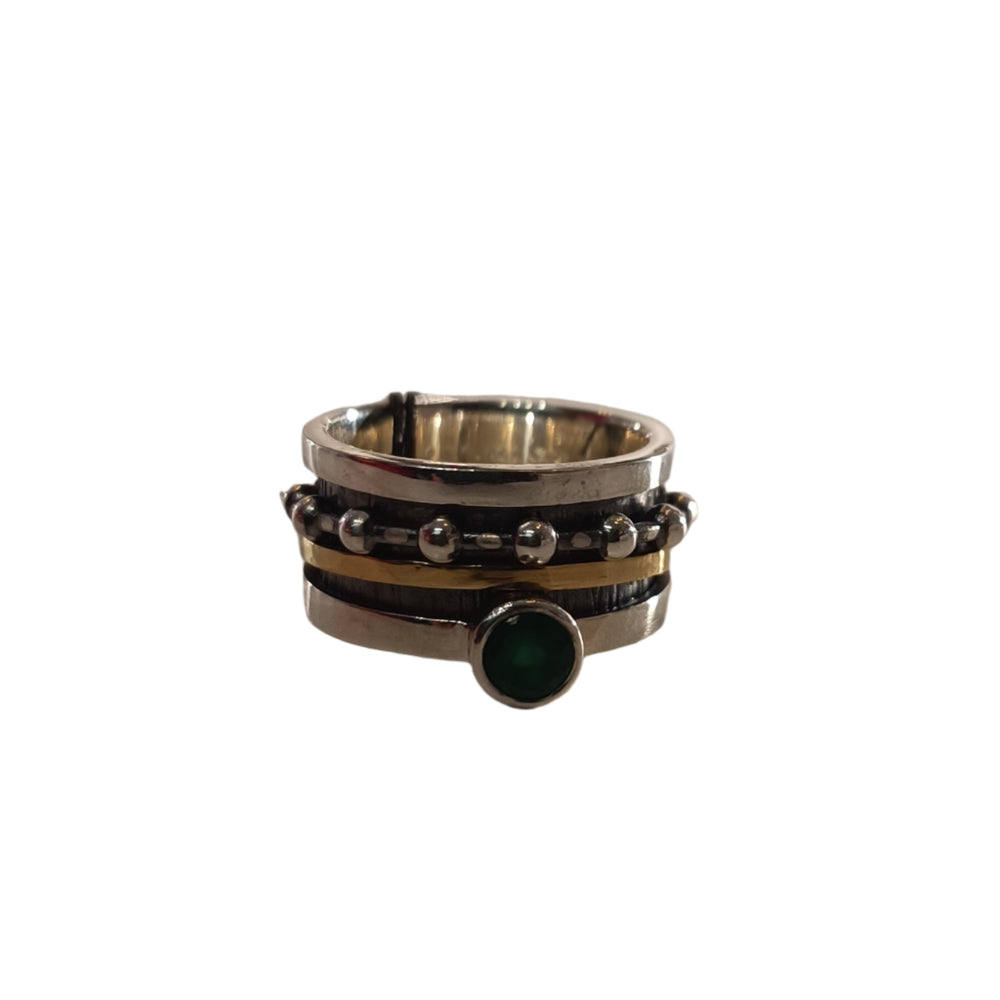 The K.And Spinning Ring Silver with Oxidisation, 18k Gold & Green CZ features layered bands, black and gold accents, silver beads, and a central round green cubic zirconia.