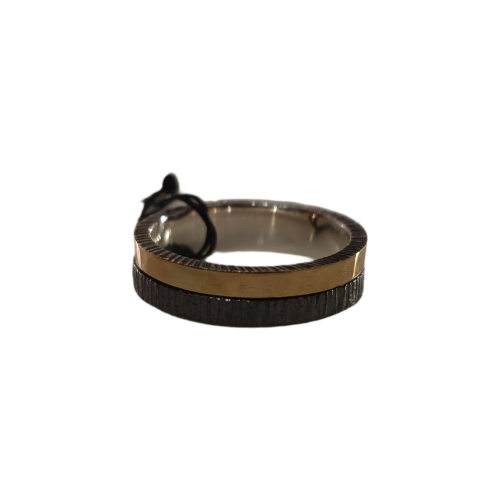The K.And Two Tone Silver Ring with Oxidisation & 18k Gold features a textured black oxidised lower band and a smooth gold upper band, shown against a white background with a small black tag attached.