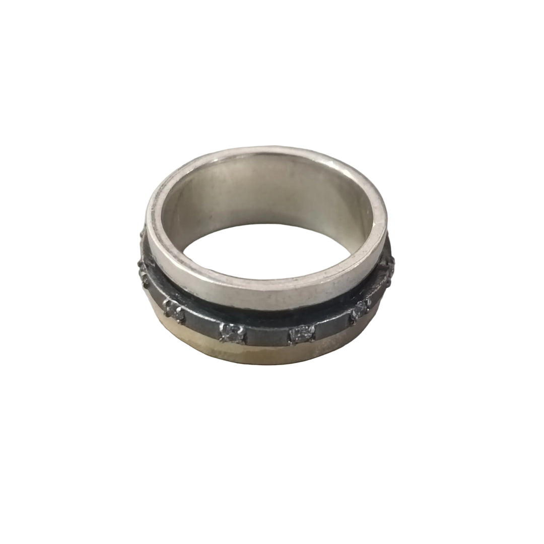 The K.And Spinner Ring in Silver & 18ct Yellow Gold with CZ features a central black band adorned with small metallic studs, set against a plain white background.