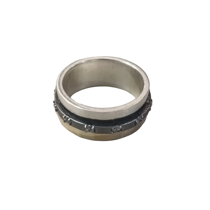 The K.And Spinner Ring in Silver & 18ct Yellow Gold with CZ features a central black band adorned with small metallic studs, set against a plain white background.
