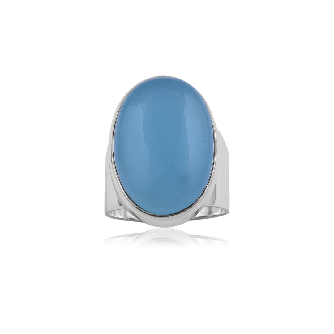 A sterling silver ring featuring a large, oval-shaped aqua chalcedony gemstone in the center. The smooth, polished gemstone has a glossy finish, and the simple band is unadorned. The Aqua chalcedony Sterling Silver Band by Watermelon tropical is displayed against a white background, its reflection faintly visible below.