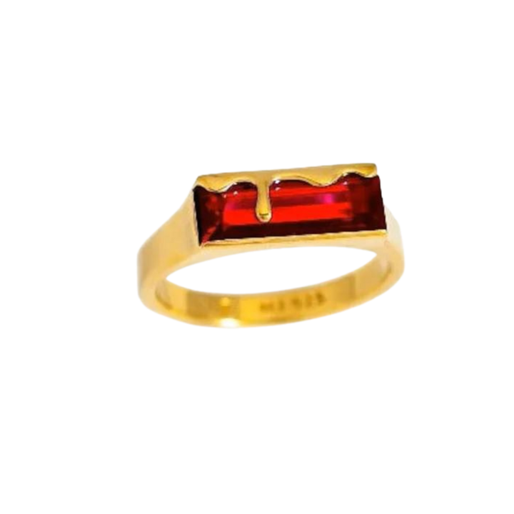 A Marie June Jewellery Dripping Gemstone Gold Ring Garnet Red featuring a horizontally set Garnet Red rectangular gemstone, with a decorative gold border resembling dripping liquid from the top. The simple, unadorned band complements the intricate design beautifully.