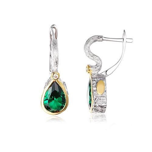 A pair of elegant Eden Earrings by Edith London featuring a teardrop-shaped green gemstone surrounded by a gold setting. The earrings have a mix of silver and gold elements with an intricate design. One earring is shown closed, while the other is open to display the latch-back closure.