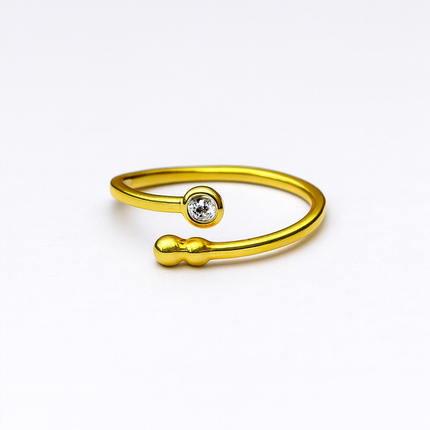 The Bauble & Stone Ring by Watermelon tropical is a minimalist handmade gold-plated sterling silver open ring featuring a round diamond on one end and an abstract accent, shown on a plain white background.