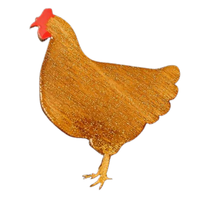 A stylized illustration of a chicken against a black background. The chicken, handpainted in a simple, solid golden color with a red comb on its head and a simplified body shape, exudes charm akin to handcrafted wooden chickens. The "Chicken Pin Brooch Gold" by Naoi captures this whimsical elegance perfectly.