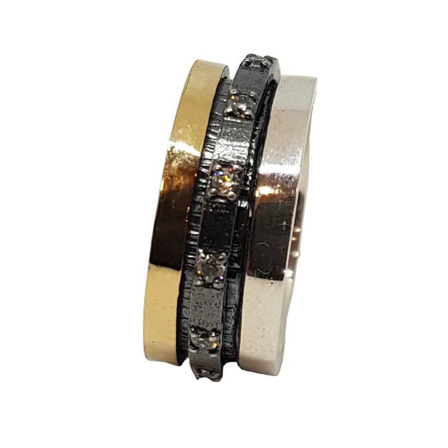 The K.And Spinner Ring in Silver & 18ct Yellow Gold with CZ features a wide gold band and a slimmer, textured silver band adorned with cubic zirconia stones, all set against a white background.