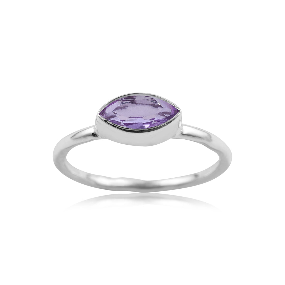 A simple silver Silver Marquise Amethyst Ring featuring a cushion-cut, purple gemstone set in a bezel setting. The band is smooth and polished, with a minimalist design that spotlights the central gemstone. The ring is displayed against a white background. This beautiful piece is brought to you by Watermelon tropical.