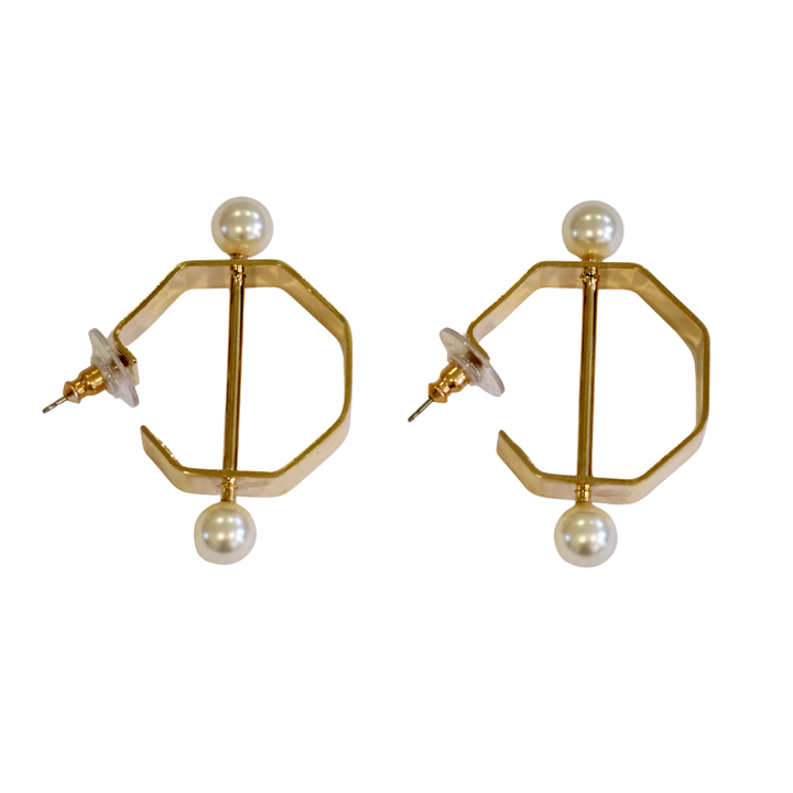 Gold Bar and Pearl Hoop Earrings by Zubeldia feature a geometric design with gold plating, hexagonal hoops, round white pearls at the top and bottom, and clear earring backs on the posts.