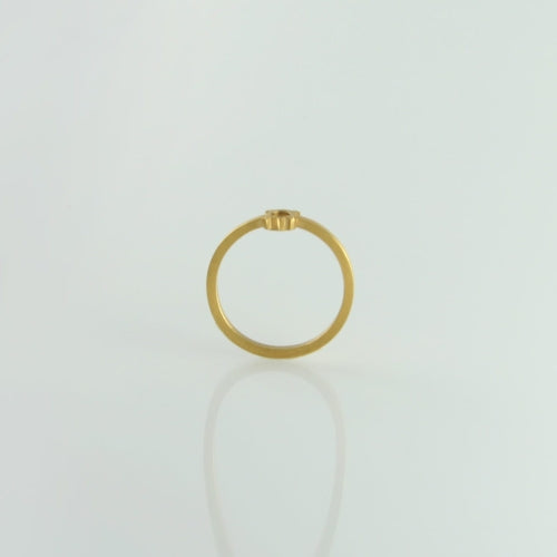 A simple 24ct gold-plated ring with a barely noticeable small square setting is pictured against a plain white background. The Fruit Bijoux Minimal Ring Gold Plate, from the Fruit Bijoux collection, is shown from a side view, emphasizing its thin band and brushed finish.