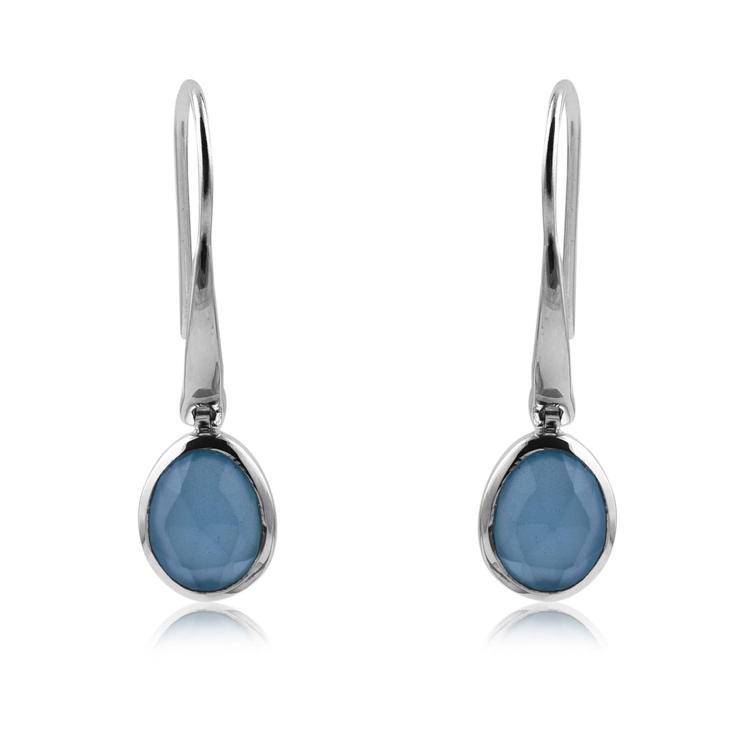 A pair of elegant Aqua Chalcedony Earrings by Watermelon Tropical, featuring oval-shaped gemstones set in a simple, sleek sterling silver bezel. The smooth, faceted surface of the gemstones adds a touch of sparkle to these hook-style drop earrings.