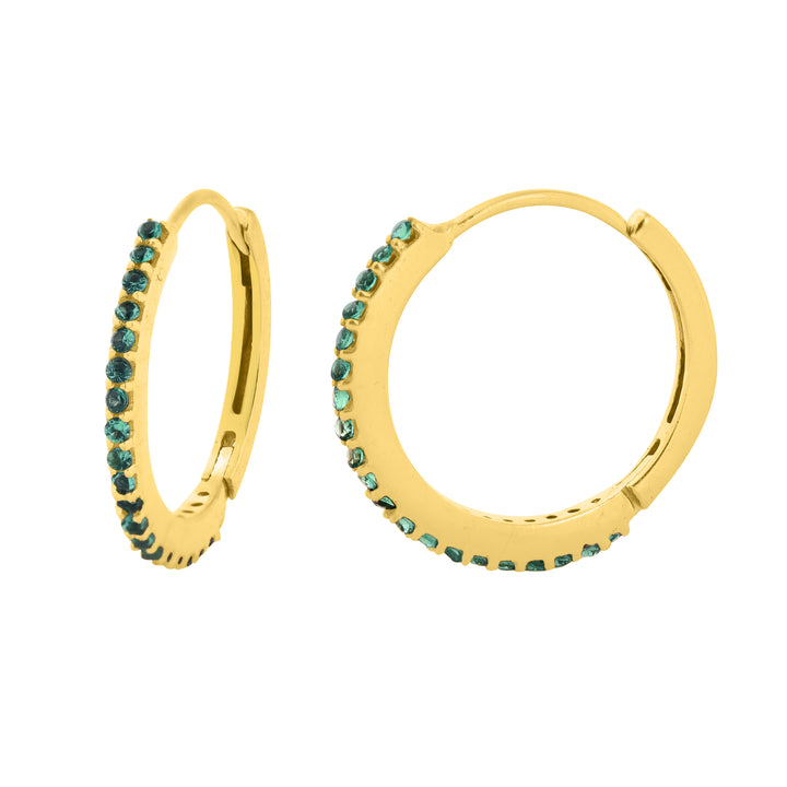 The Aoife Gold Hoops with Cubic Zirconia in various colours by Watermelon Tropical feature a pair of gold-plated brass hoops adorned with small green gemstones along the outer edge. Measuring 15mm in diameter, these hoop earrings showcase a thin, circular design and a latch-back closure mechanism. They are displayed against a plain white background.